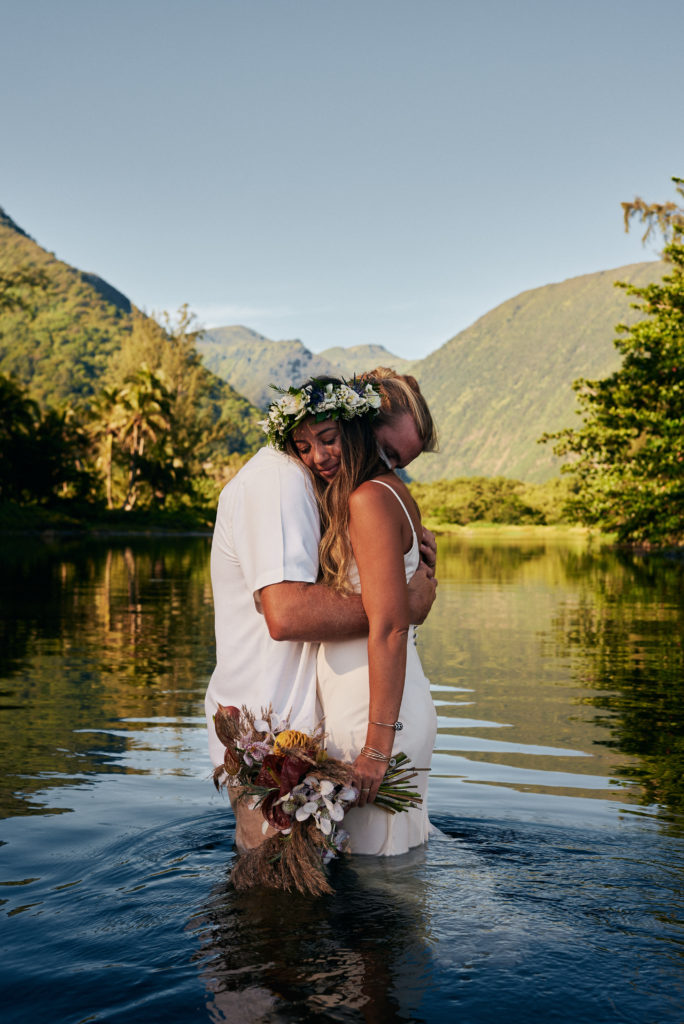 Keana and Dylan embrace as husband and wife in river in Hawaii